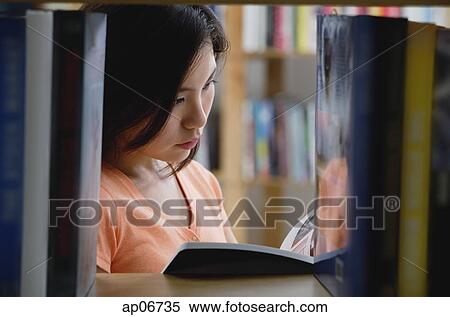 Young woman in library View Large Photo Image Stock Photography - Young woman in library. Fotosearch