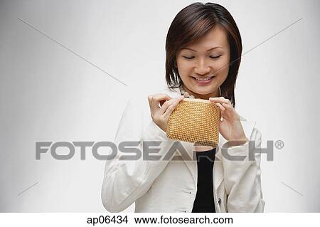 Young woman looking into purse View Large Photo Image Picture - Young woman looking into purse. Fotosearch