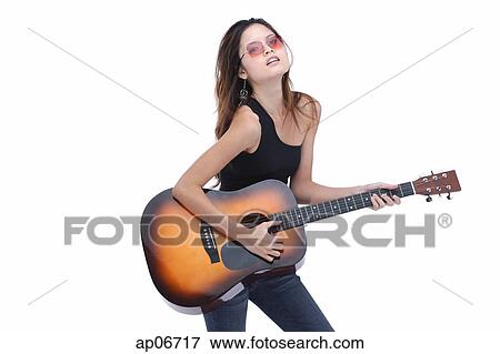 Young woman playing guitar View Large Photo Image Stock Photo - Young woman playing guitar. Fotosearch