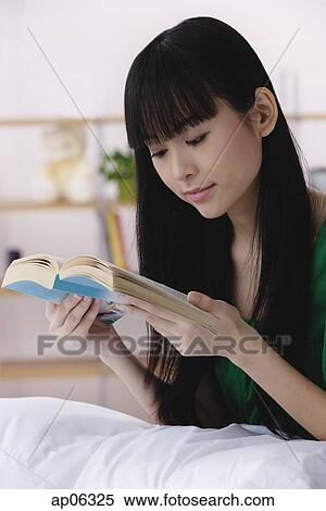 Young woman reading a book View Large Photo Image Stock Photography - Young woman reading a book. Fotosearch