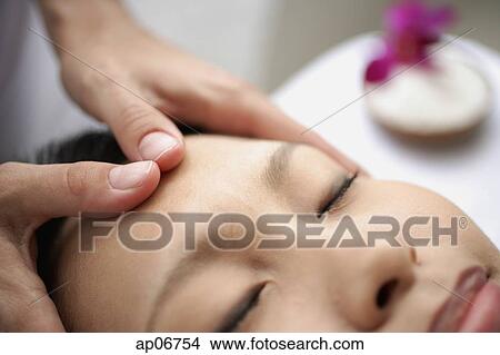 Young woman receiving head massage View Large Photo Image Picture - Young woman receiving head massage. Fotosearch