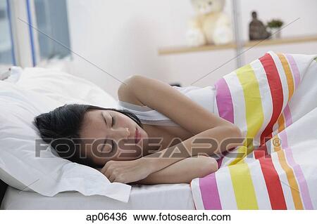 Young woman sleeping in bed View Large Photo Image Stock Photograph - Young woman sleeping in bed. Fotosearch