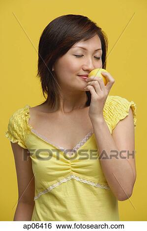 Young woman smelling lemon View Large Photo Image Stock Photograph - Young woman smelling lemon. Fotosearch