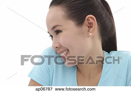 Young woman smiling, looking away, side view View Large Photo Image Stock Photo - Young woman smiling, looking away, side view. Fotosearch