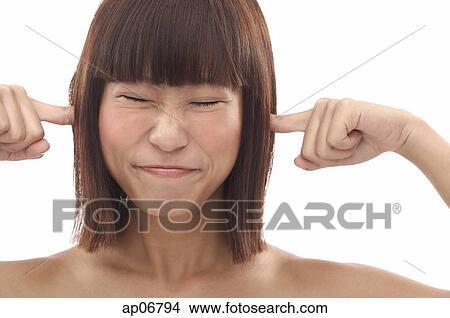 Picture - Young woman sticking fingers into her ears. Fotosearch