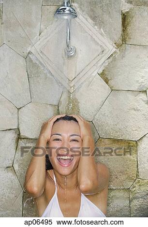 Young woman under shower, smiling View Large Photo Image Stock Photography - Young woman under shower, smiling. Fotosearch