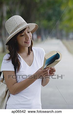 Young woman wearing hat, reading a book View Large Photo Image Stock Image - Young woman wearing hat, reading a book. Fotosearch