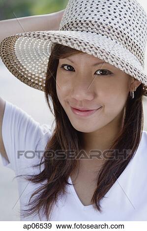 Young woman wearing hat View Large Photo Image Stock Photo - Young woman wearing hat. Fotosearch