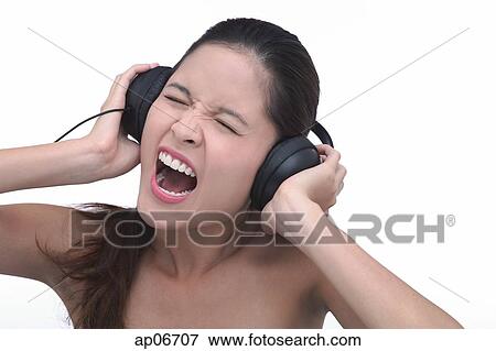 Young woman wearing headphones, screaming View Large Photo Image Stock Photo - Young woman wearing headphones, screaming. Fotosearch