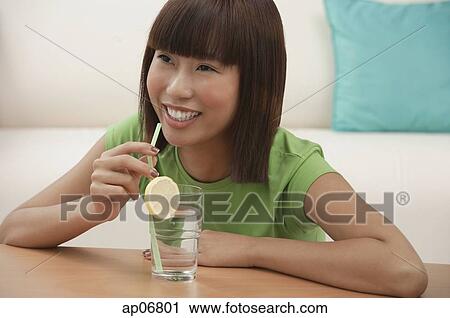 Young woman with a glass of water View Large Photo Image Stock Image - Young woman with a glass of water. Fotosearch