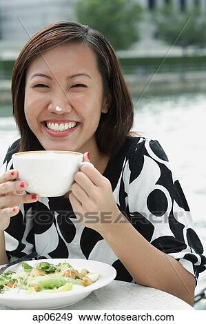 Young woman with cappuccino cup, foam on her nose View Large Photo Image Stock Photo - Young woman with cappuccino cup, foam on her nose. Fotosearch