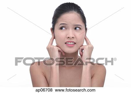 Young woman with fingers in ears View Large Photo Image Stock Photo - Young woman with fingers in ears. Fotosearch