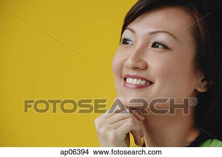 Young Woman with hand on chin, smiling View Large Photo Image Picture - Young Woman with hand on chin, smiling. Fotosearch