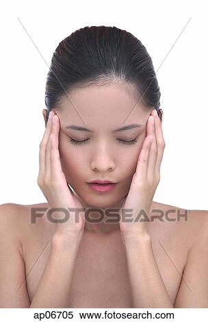 Young woman with hands on head, eyes closed View Large Photo Image Stock Photography - Young woman with hands on head, eyes closed. Fotosearch