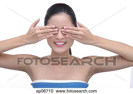 Young woman with hands over eyes View Large Photo Image Stock Image - Young woman with hands over eyes. Fotosearch