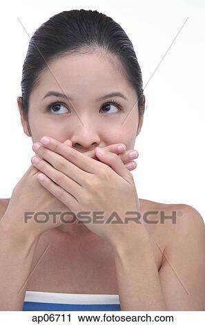 Young woman with hands over mouth View Large Photo Image Stock Image - Young woman with hands over mouth. Fotosearch