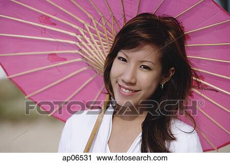Young woman with pink umbrella View Large Photo Image Stock Image - Young woman with pink umbrella. Fotosearch