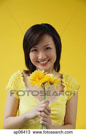 Young woman with stalks of yellow flowers View Large Photo Image Stock Image - Young woman with stalks of yellow flowers. Fotosearch