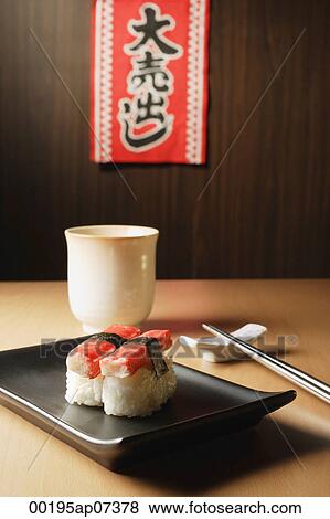 Stock Photo - 2 pieces of sushi, Kanikama Nigiri, crabstick on tray, "for sale", sale sign. Fotosearch