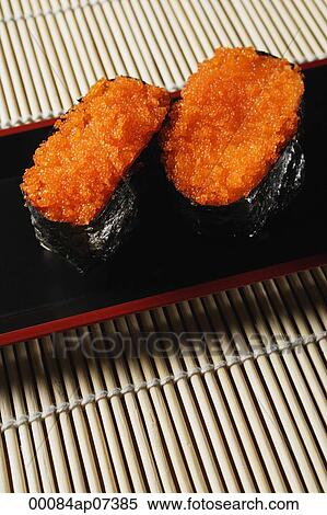 2 pieces of sushi, Tobiko Gunkan, fish roe View Large Photo Image Stock Photography - 2 pieces of sushi, Tobiko Gunkan, fish roe. Fotosearch