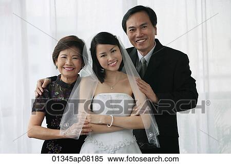 A bride and her family smile at the camera together View Large Photo Image Stock Photography - A bride and her family smile at the camera together. Fotosearch