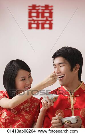 A bride feeds the groom soup from a spoon View Large Photo Image Picture - A bride feeds the groom soup from a spoon. Fotosearch