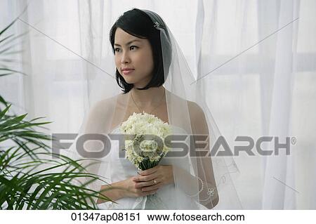 A bride holds a bouquet of flowers View Large Photo Image Stock Image - A bride holds a bouquet of flowers. Fotosearch