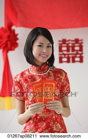 A bride smiles as she holds two red envelopes View Large Photo Image Stock Image - A bride smiles as she holds two red envelopes. Fotosearch
