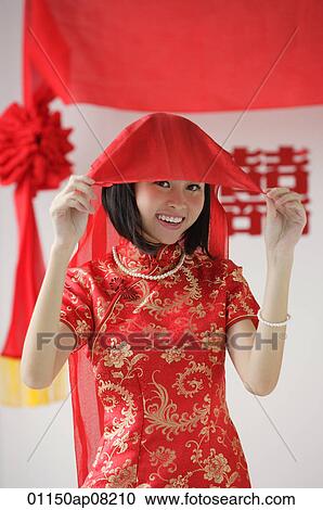 A bride wearing a red silk dress smiles at the camera View Large Photo Image Stock Image - A bride wearing a red silk dress smiles at the camera. Fotosearch