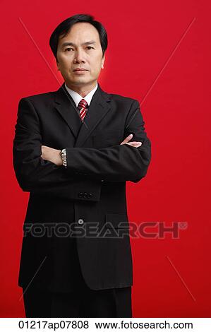 Stock Photo - A businessman crosses his arms. Fotosearch