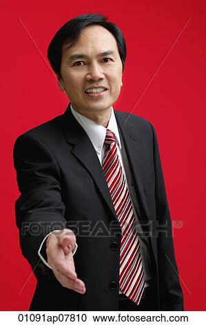 A businessman extends his hand to shake hands View Large Photo Image Stock Image - A businessman extends his hand to shake hands. Fotosearch