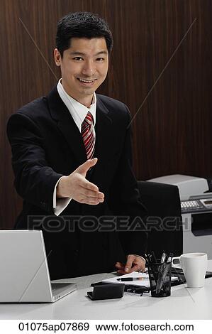 A businessman extends his hand to shake hands View Large Photo Image Stock Photo - A businessman extends his hand to shake hands. Fotosearch