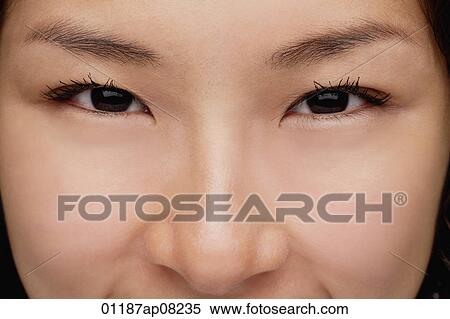 Stock Photography - A close-up of a young woman looking at the camera. Fotosearch