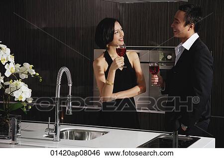 A couple have a glass of red wine together View Large Photo Image Stock Photograph - A couple have a glass of red wine together. Fotosearch