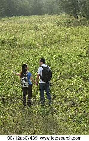 A couple hiking outdoors in the nature View Large Photo Image Stock Photo - A couple hiking outdoors in the nature. Fotosearch