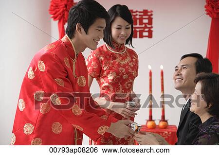 A groom offers a cup of tea to another family member View Large Photo Image Stock Photograph - A groom offers a cup of tea to another family member. Fotosearch