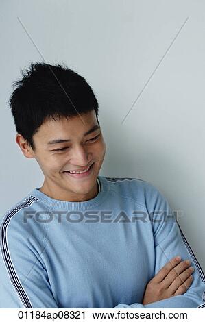 A man crosses his arms and smiles View Large Photo Image Stock Image - A man crosses his arms and smiles. Fotosearch