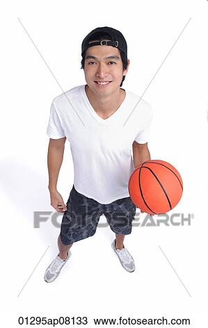 A man holds a basketball and smiles at the camera View Large Photo Image Stock Image - A man holds a basketball and smiles at the camera. Fotosearch