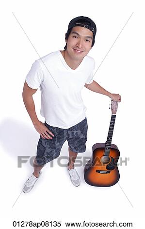 A man holds a guitar and smiles at the camera View Large Photo Image Stock Photography - A man holds a guitar and smiles at the camera. Fotosearch