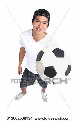 A man holds a soccerball and smiles at the camera View Large Photo Image Picture - A man holds a soccerball and smiles at the camera. Fotosearch