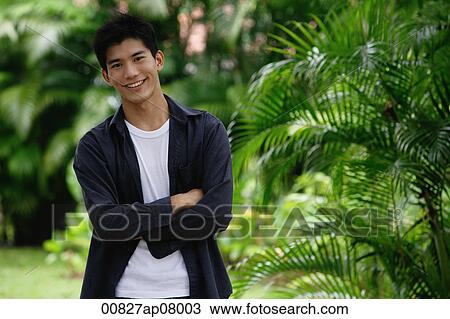 Stock Image - A man in a garden smiles at the camera. Fotosearch