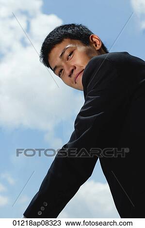 A man in a suit smiles at the camera View Large Photo Image Stock Image - A man in a suit smiles at the camera. Fotosearch