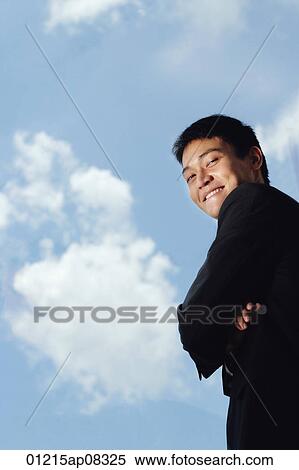 A man in a suit smiles at the camera View Large Photo Image Stock Photography - A man in a suit smiles at the camera. Fotosearch
