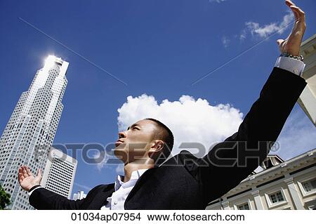 A man in a suit with a skyscraper behind him View Large Photo Image Picture - A man in a suit with a skyscraper behind him. Fotosearch