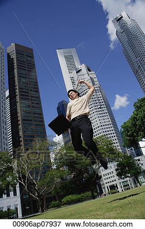 A man jumps in the air with his laptop View Large Photo Image Stock Photo - A man jumps in the air with his laptop. Fotosearch
