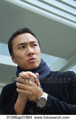 A man rubs his hands together to keep warm View Large Photo Image Picture - A man rubs his hands together to keep warm. Fotosearch