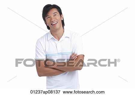 A man smiles and crosses his arms View Large Photo Image Stock Photo - A man smiles and crosses his arms. Fotosearch
