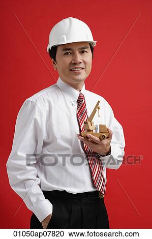 A man wearing a shirt and tie with a hardhat View Large Photo Image Stock Image - A man wearing a shirt and tie with a hardhat. Fotosearch
