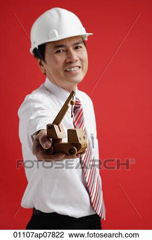 A man wearing a shirt and tie with a hardhat View Large Photo Image Stock Image - A man wearing a shirt and tie with a hardhat. Fotosearch