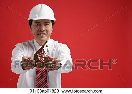 A man wearing a shirt and tie with a hardhat View Large Photo Image Stock Image - A man wearing a shirt and tie with a hardhat. Fotosearch